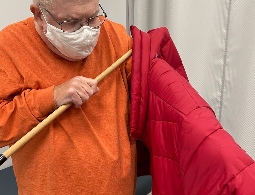 occupational therapy services at professional rehab associates in Radford, Virginia patient putting on coat